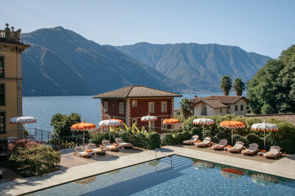 The bright orange umbrellas and floating swimming pool of Grand Hotel Tremezzo.