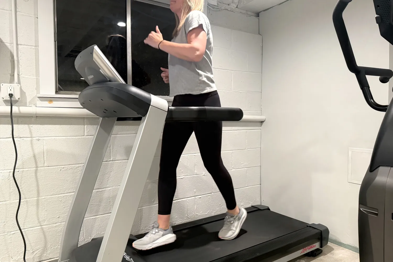 A person running on a treadmill wearing the Altra Women's Paradigm 8 shoes.