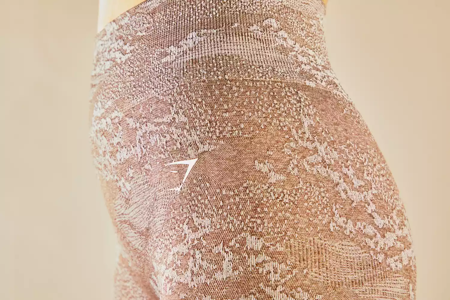 Close-up of the textured fabric and brand logo on Gymshark Adapt Camo Seamless Leggings.