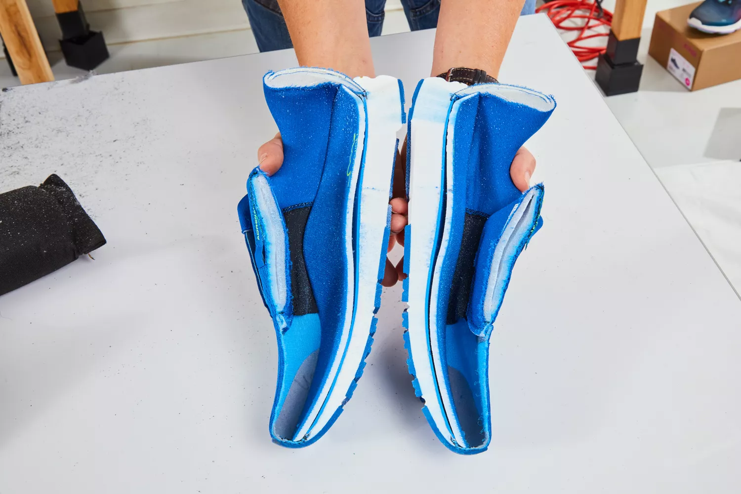 Two halves of a cut-open running shoe revealing the internal midsole structure.