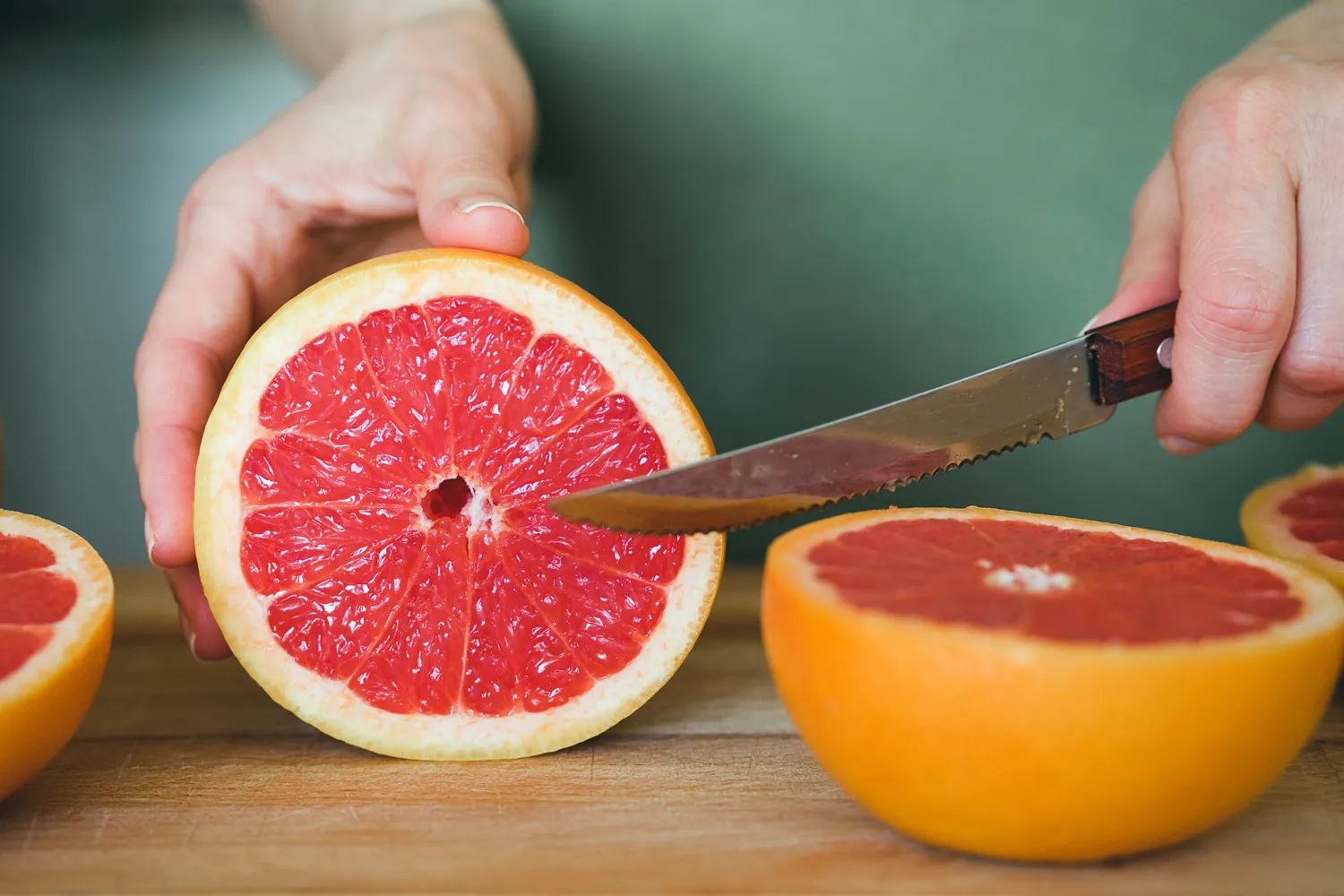 Top-down view of a thinly sliced red grapefruit.
