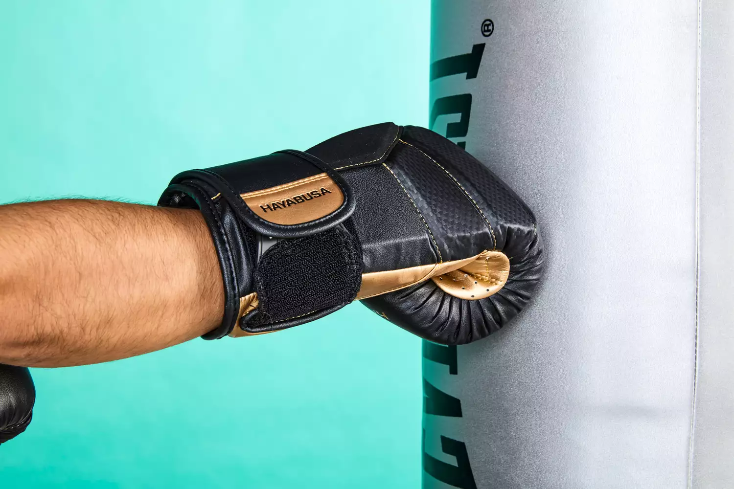 Close-up of a Hayabusa T3 glove impacting a heavy bag.