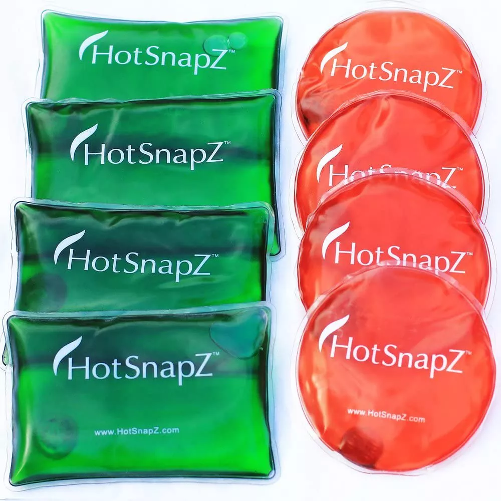 Multiple red and green HotSnapZ gel heat packs in circular and rectangular shapes.