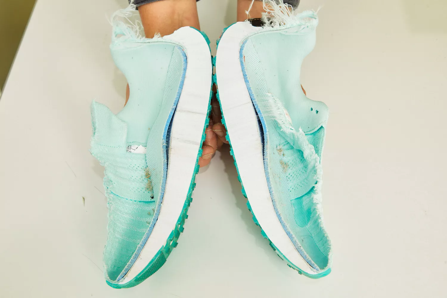 A Nike running shoe cut in half to show internal foam layers and construction.