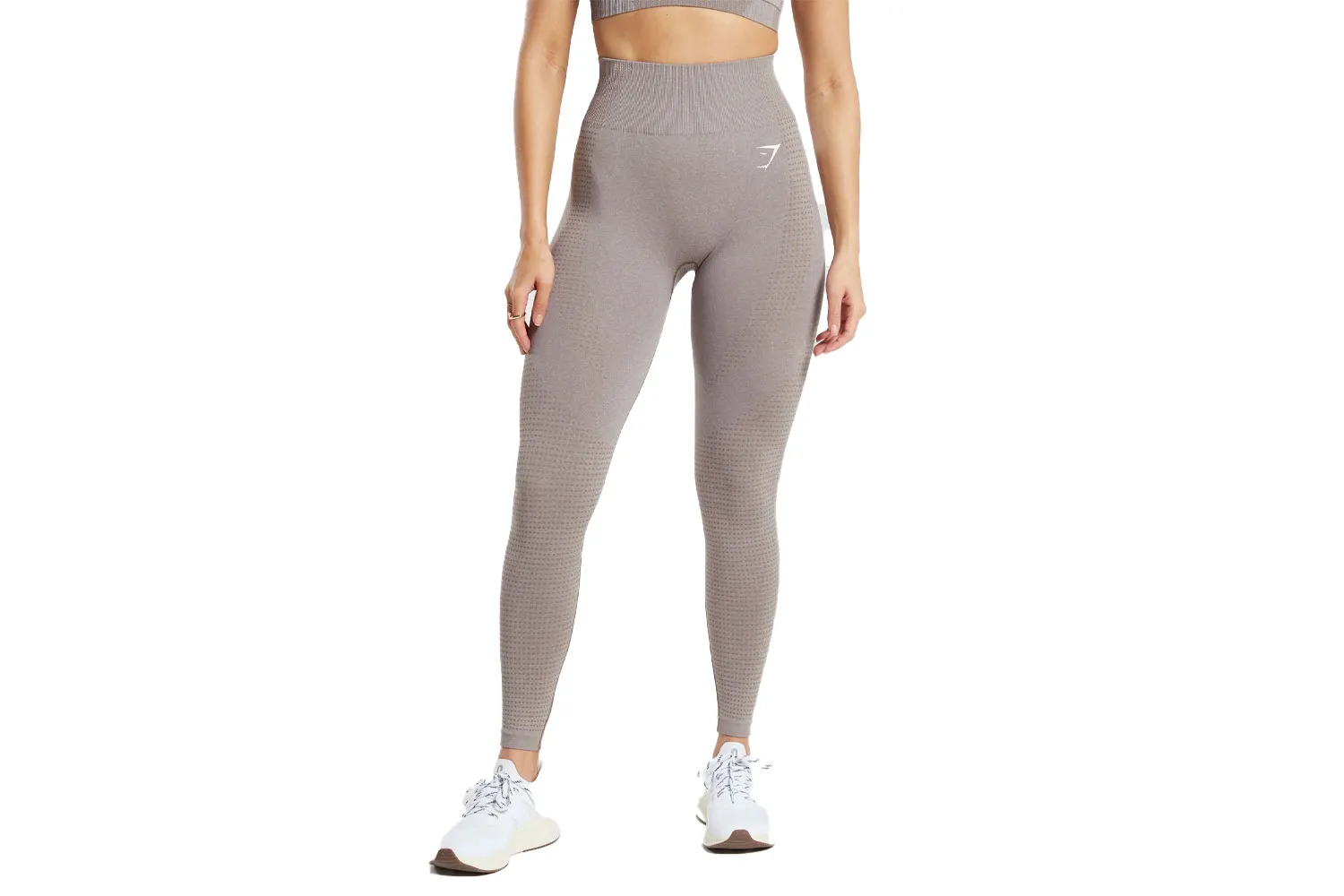 A model wearing grey textured Gymshark Vital Seamless leggings and a matching crop top.