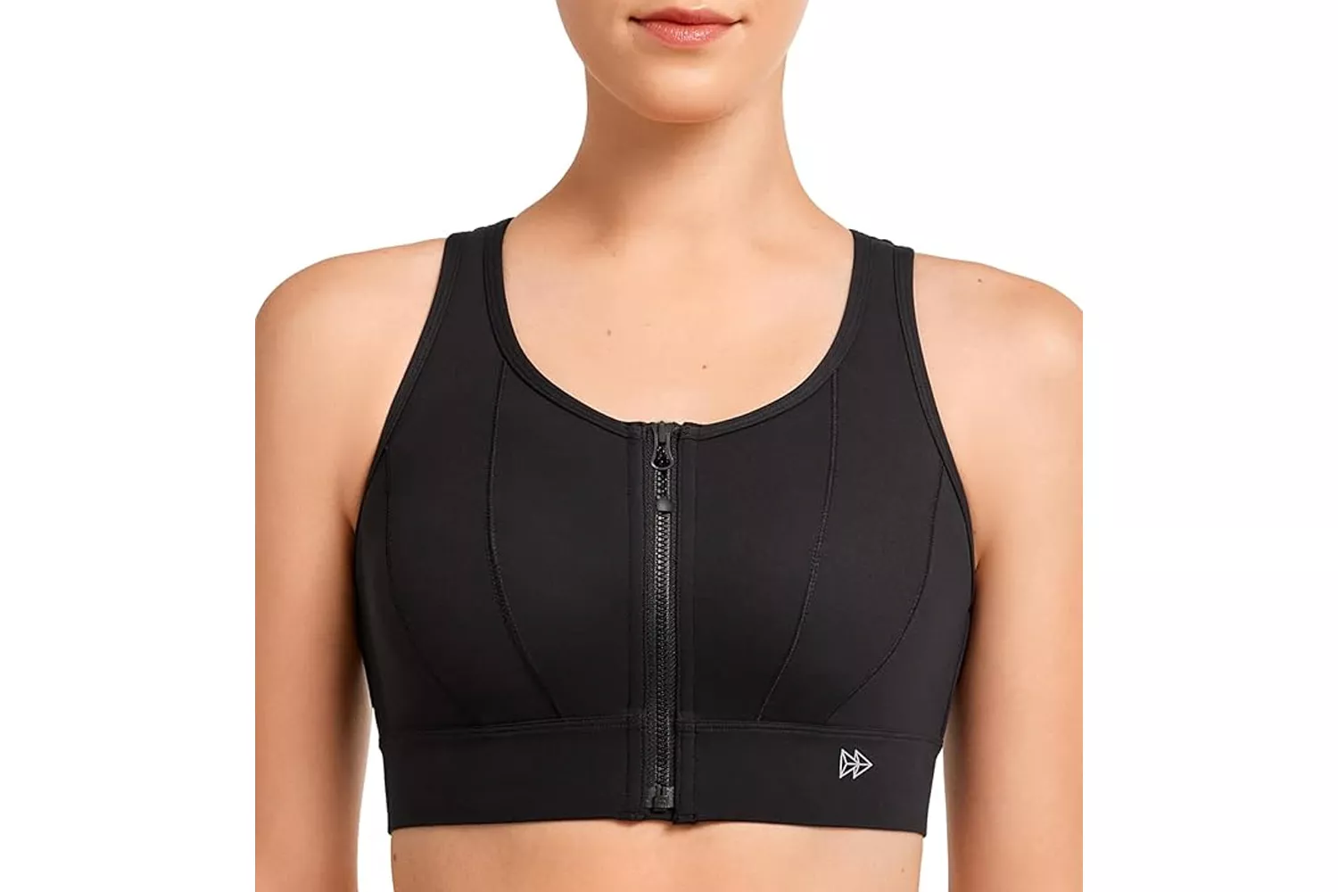 A woman modeling a black sports bra with a prominent front zipper.