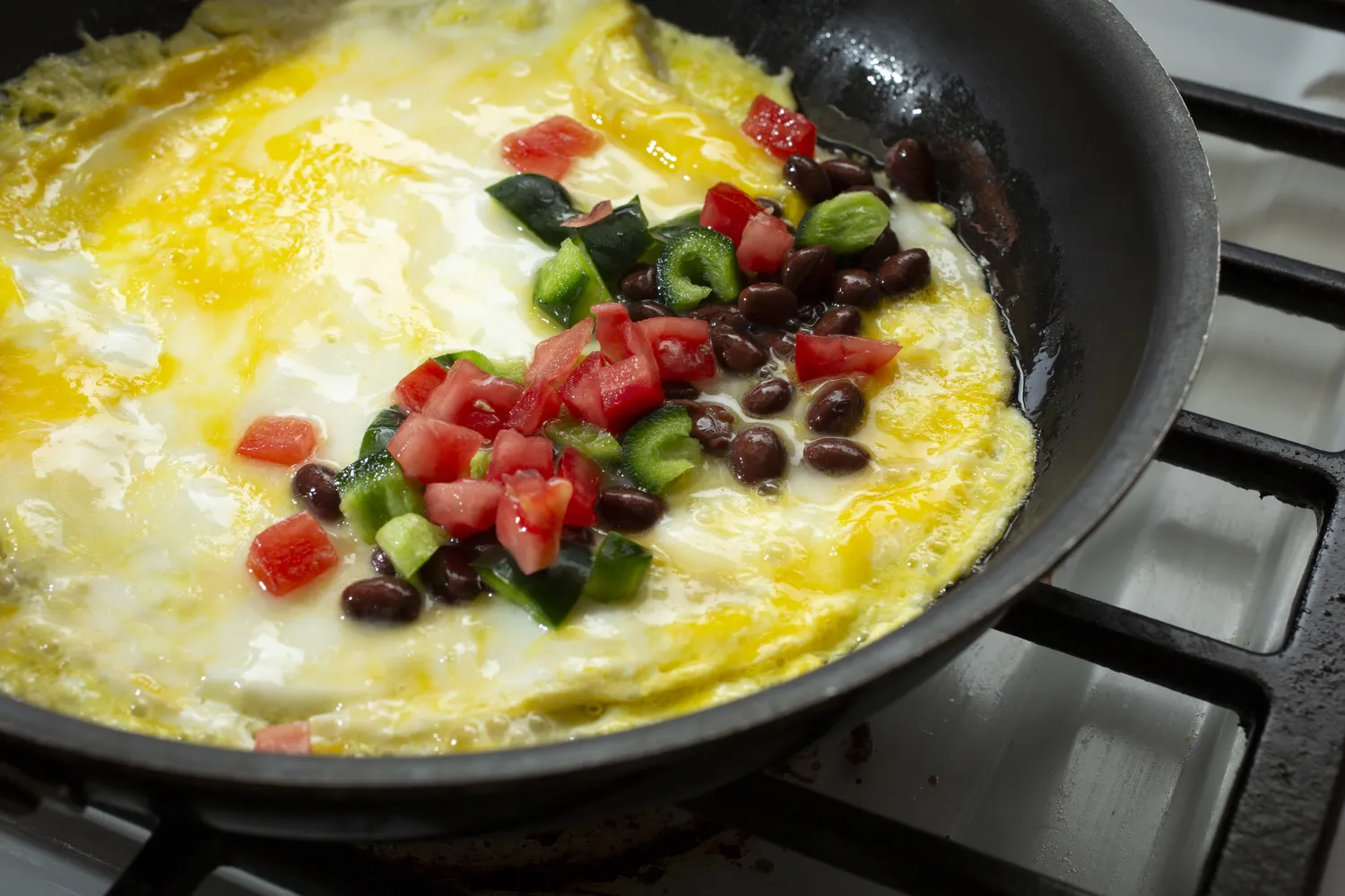 An omelet served with beans and vegetables.