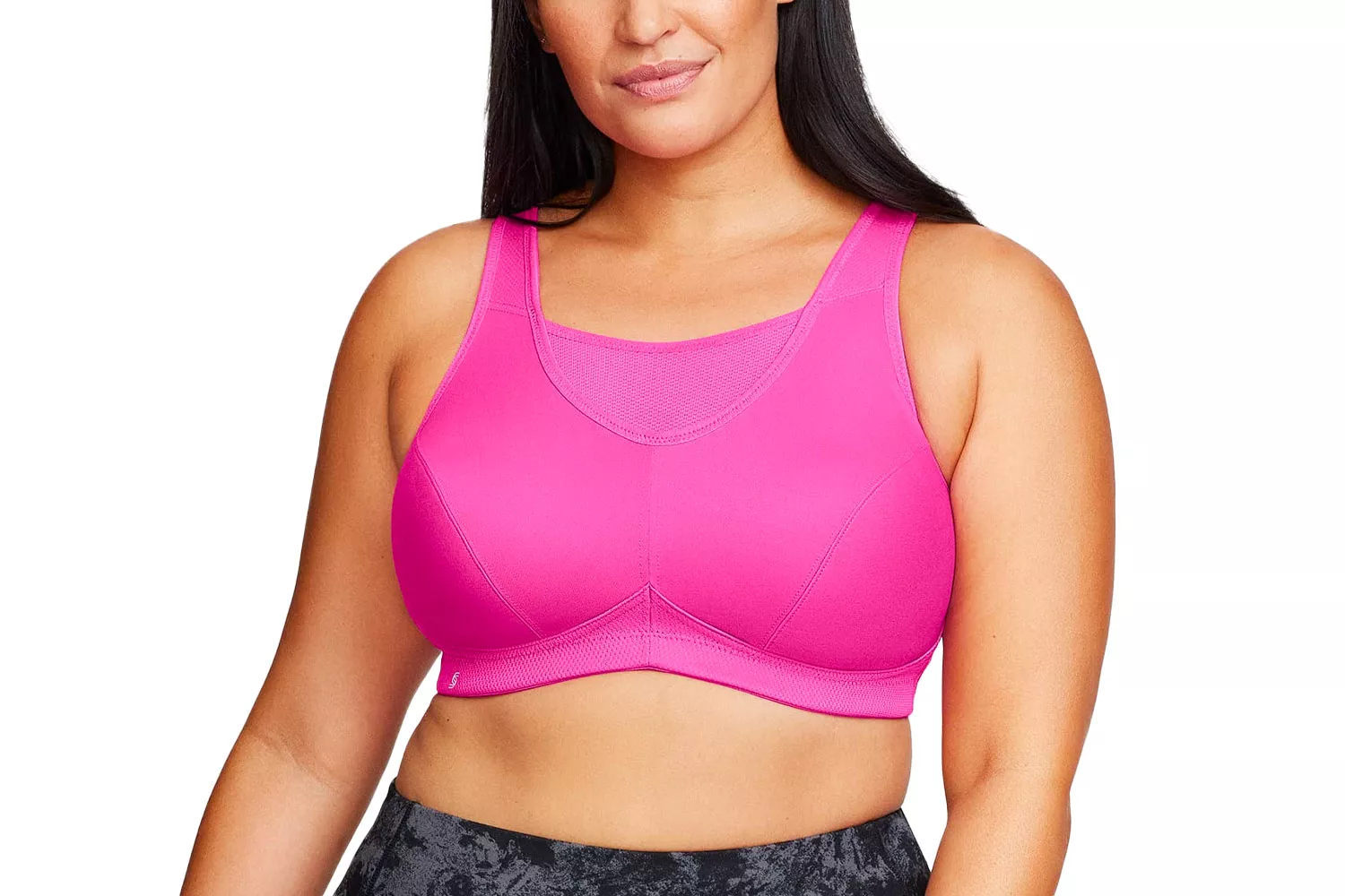 A woman modeling a bright pink high-support sports bra against a white background.