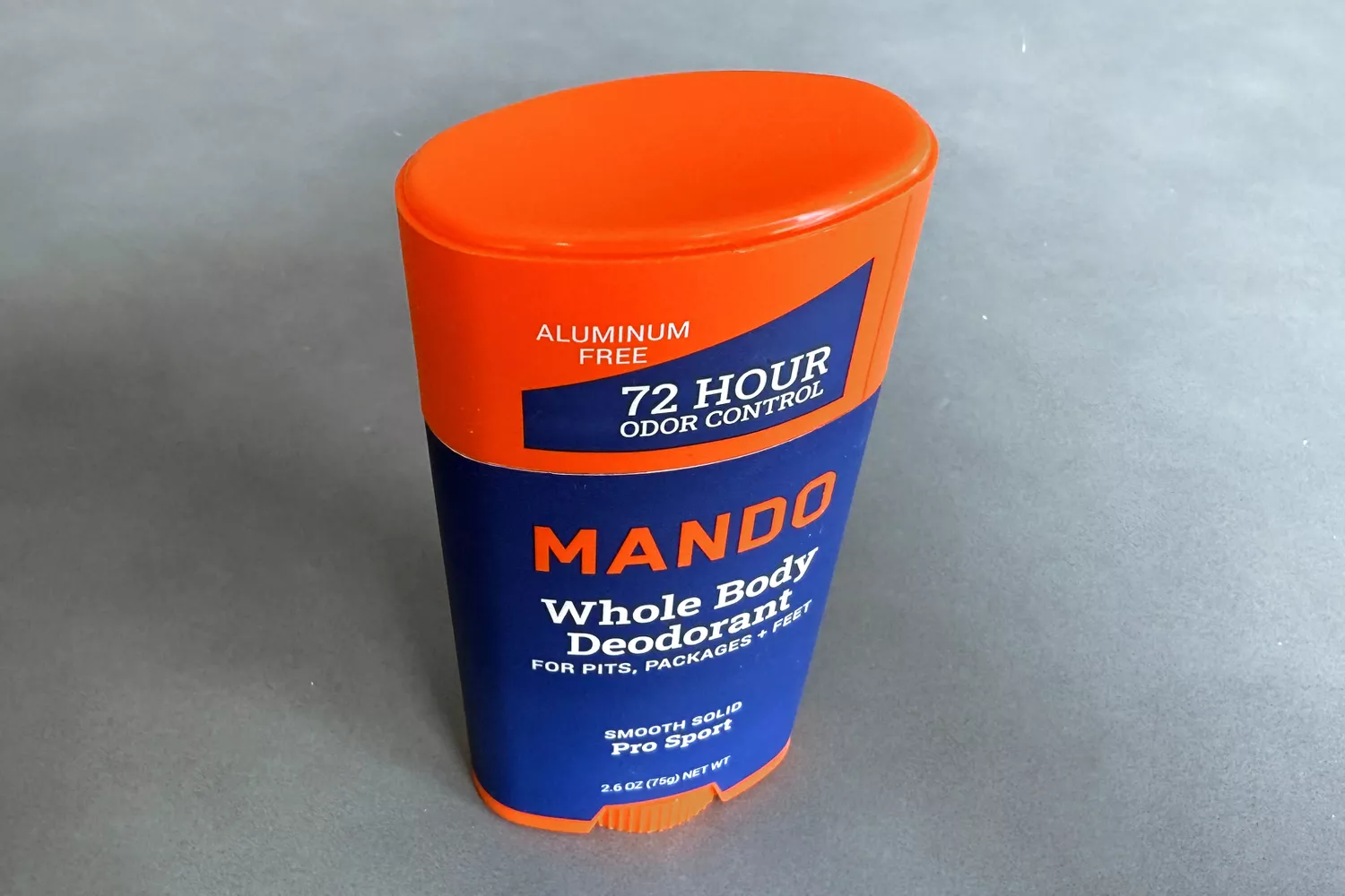 A Mando Whole Body Deodorant stick in Pro Sport scent, orange and blue packaging.