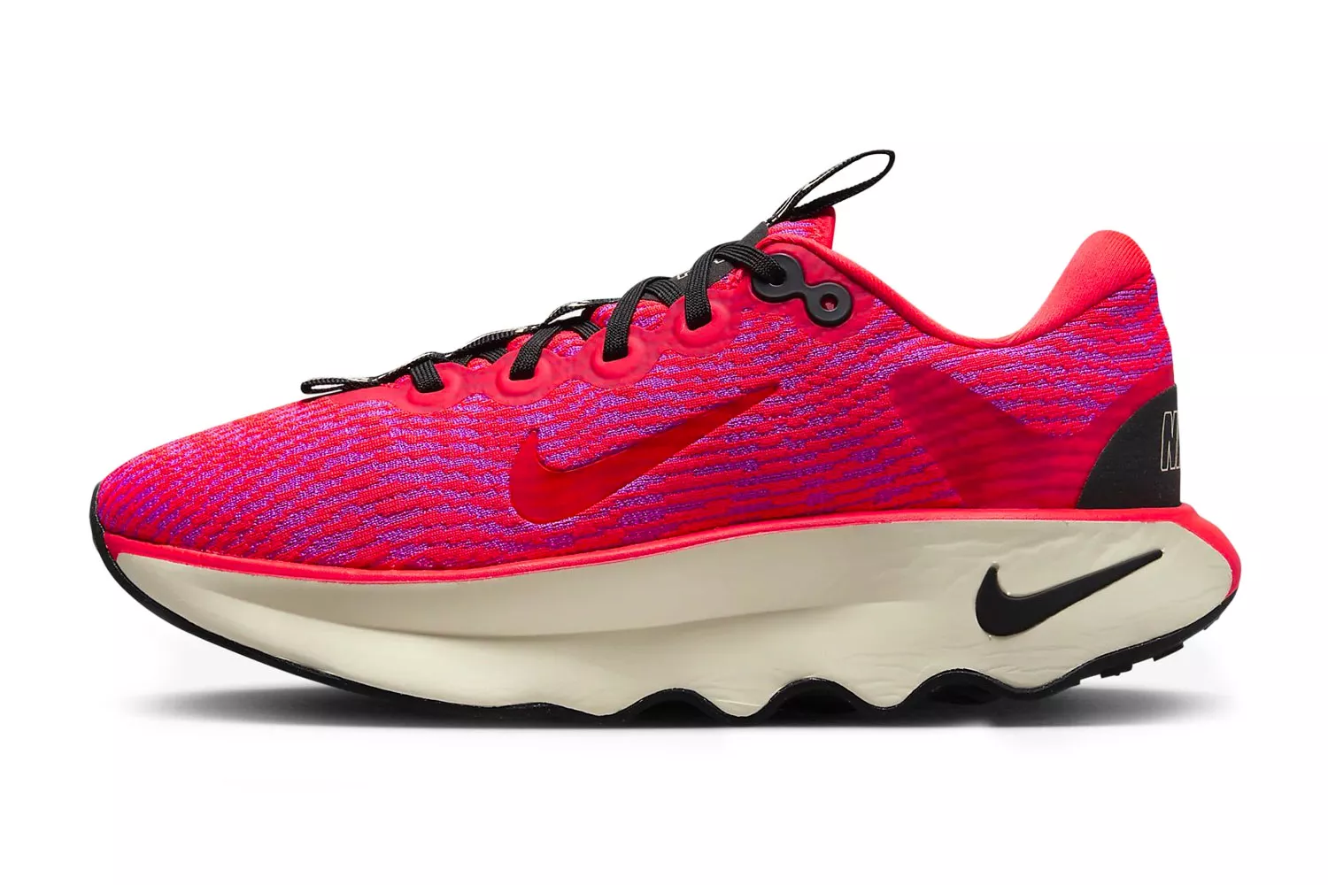 Side profile of a red and purple Nike Motiva shoe highlighting its thick, curved rocker sole.