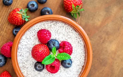 Chia seed pudding topped with fresh raspberries and blueberries in a bowl.