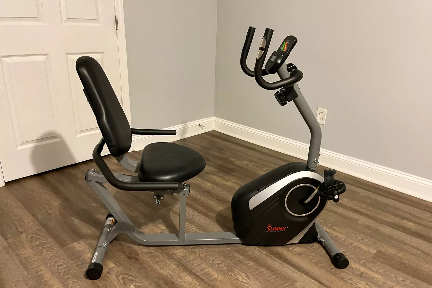 The Sunny Health & Fitness magnetic recumbent exercise bike with a wide padded seat.