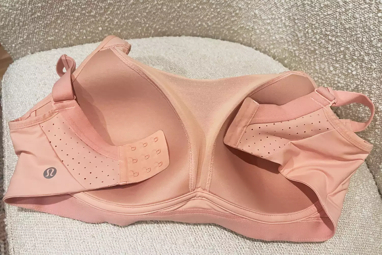 Pink Lululemon Run Times Bra with breathable perforated panels and adjustable straps.