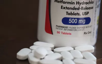 A bottle of Metformin tablets, representing the broader medical management of diabetes-related risks.