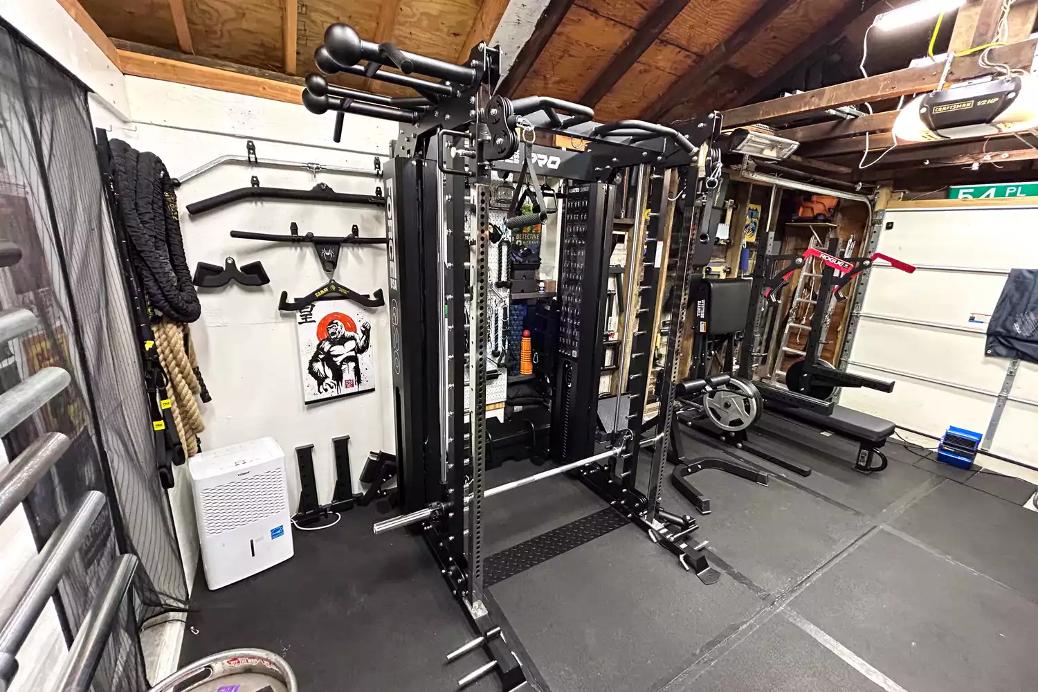 A fully equipped home gym featuring the Force USA G20 Pro power rack and various attachments.