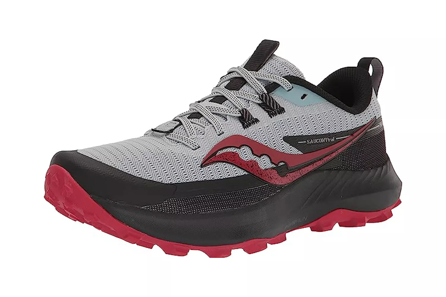 A gray and red Saucony trail running shoe with aggressive outsole lugs.